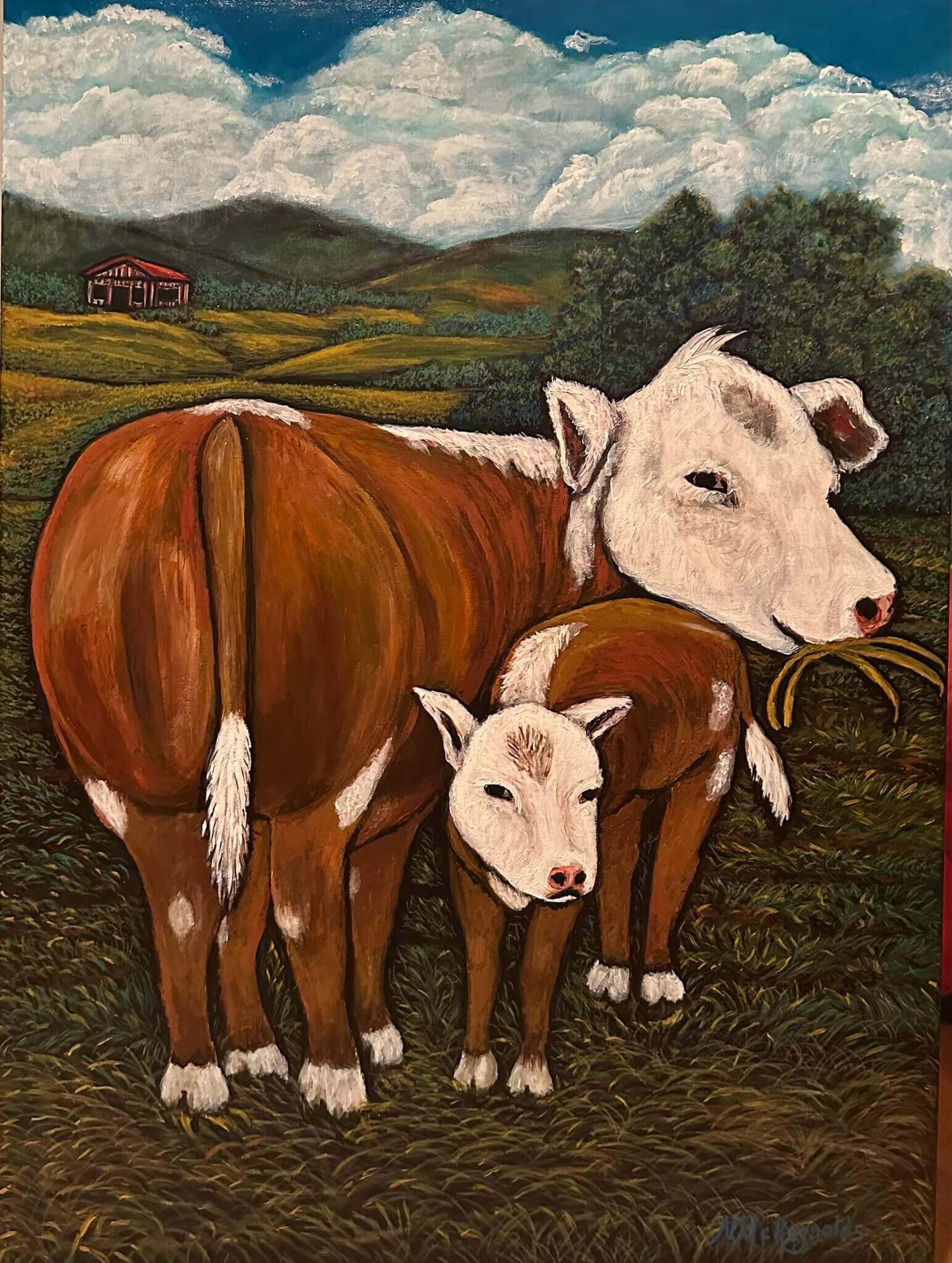 A mother cow standing over her child